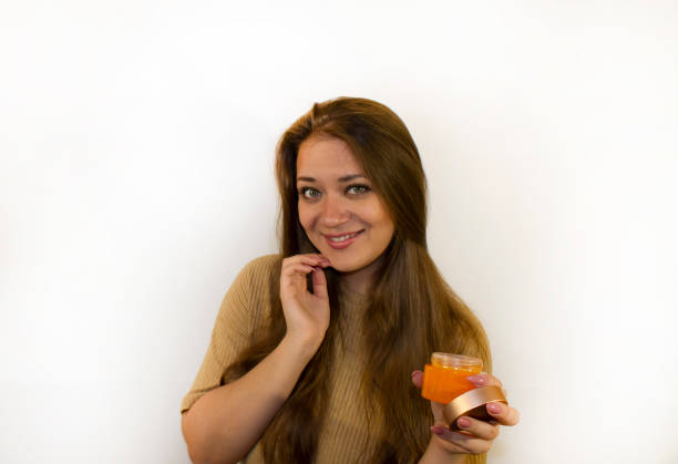 istock young beautiful woman uses face cream 1359455548