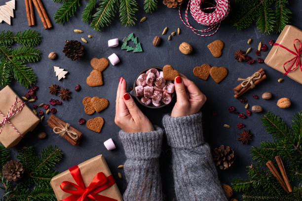 istock Christmas, female hands with gift boxes and cup of cocoa 1359462034