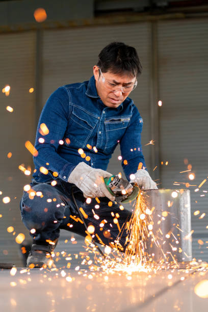 istock Craftsman grinding metal in his workshop 1359467575