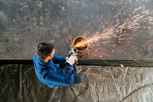 Over head view of a metal worker with sparks flying. Okayama, Japan