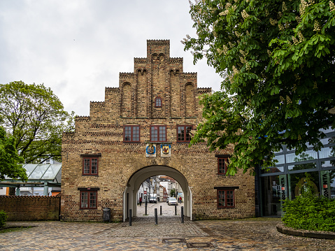 Flensburg, Germany - May 27, 2021: Historic city gate Nordertor, North gate in Flensburg, Germany. It was built in 1595. Today it's the symbol for Flensburg and a gate to North street