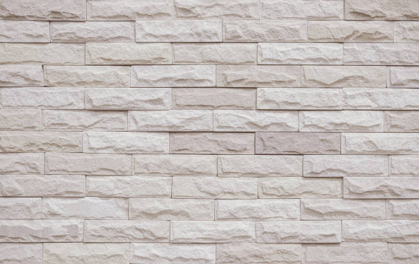 istock Cream and beige brick wall texture background. Brickwork and stonework flooring interior rock old pattern clean concrete grid uneven bricks office design. Background of old vintage brick wall backdrop 1359469434