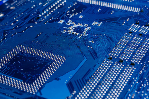 istock Motherboard surface in blue close up, selective focus 1359470943