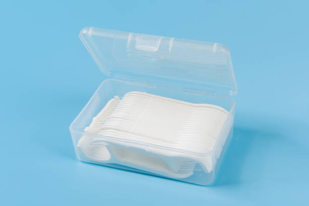 istock white dental toothpick with dental floss in box on blue background. 1359474357