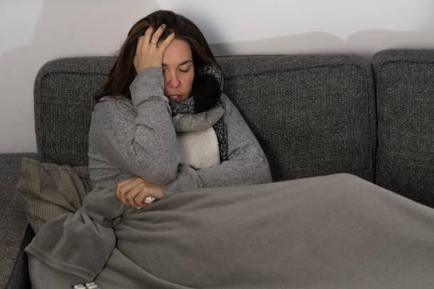 istock sick young girl lying on the sofa at home 1359474737