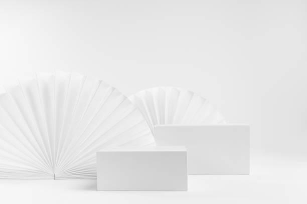 istock White abstract modern simple scene with two rectangle box podiums mockup for presentation of cosmetic product, advertising, design with light oriental folds paper fans in chinese style, front view. 1359476358