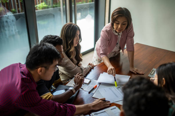 istock Multiracial group of asian business people having a work discussion 1359479109