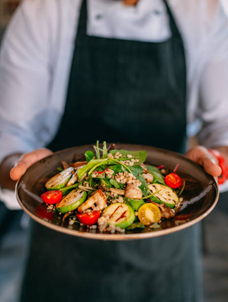 istock Chef Offers His Prepared Vegan Salad 1359479786