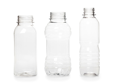 three different empty plastic bottles isolated on white background.