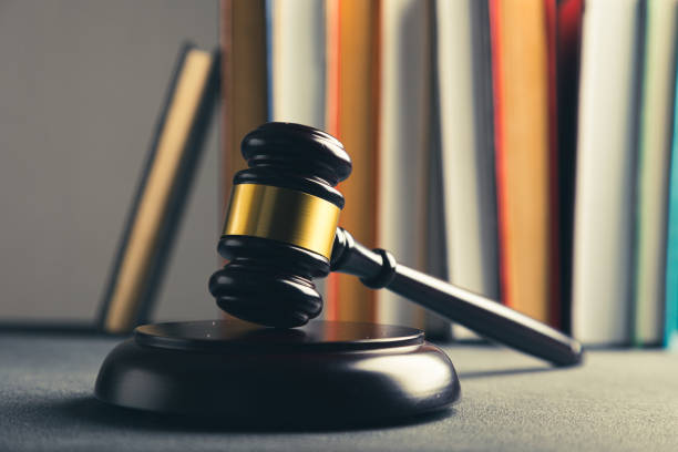 istock Law theme, judge gavel on a dark table with a book. 1359480308