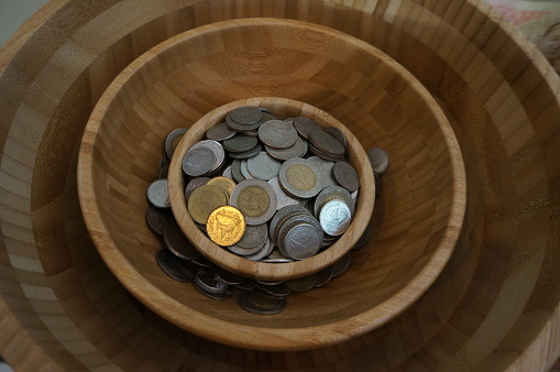 coins in the wood bowl