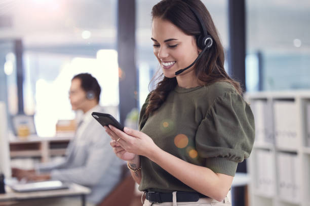 istock Shot of a young female call center agent using a phone at work 1359481806