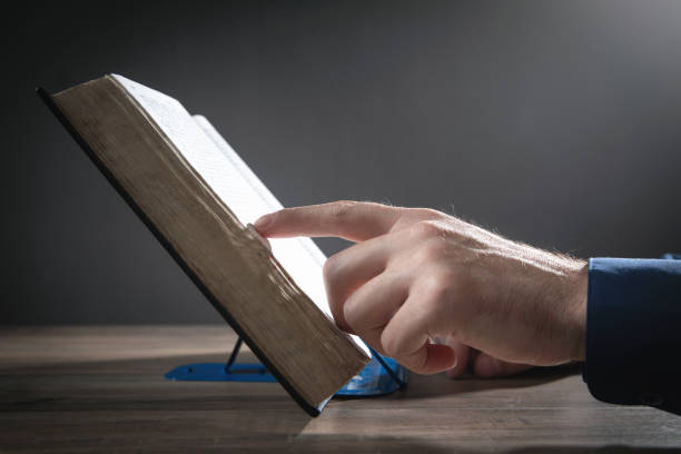 istock Caucasian man reading the Holy Bible. 1359482948