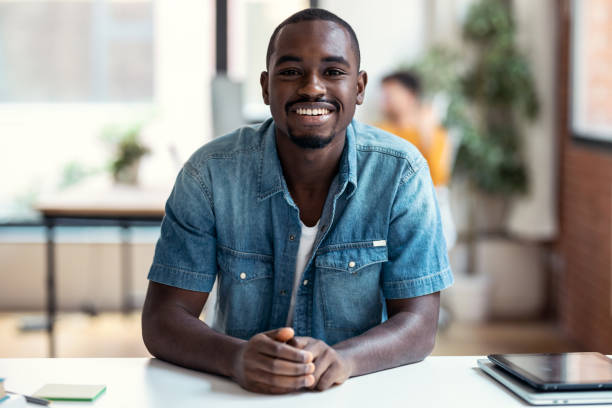 istock Afro-american business man entrepreneur looking at camera while working in a modern startup. 1359483973