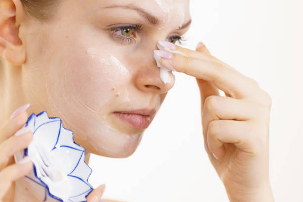 istock Girl apply cream cosmetic 1359485630