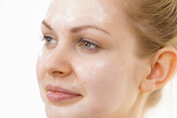 istock Girl with cream moisture cosmetic on face 1359485668