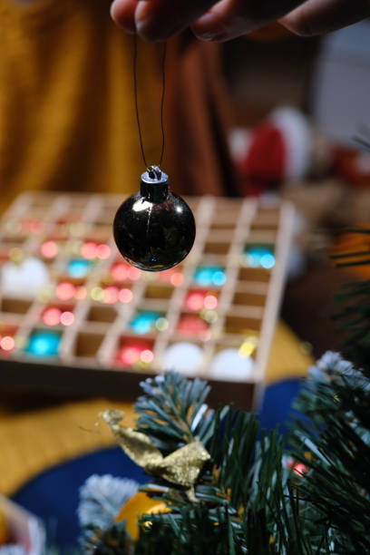 istock Unrecognizable person is decorating the Christmas tree 1359485736