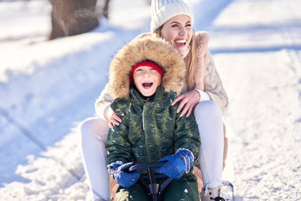 istock Nice happy family having fun on winter snow 1359486037