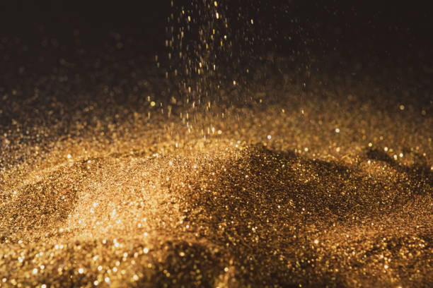 istock Sprinkle glittering gold powder elegant and precious on a black background 1359486042