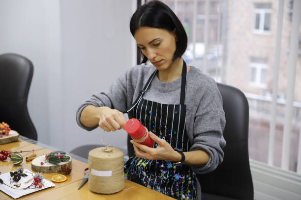 A girl winds a rope around a candle