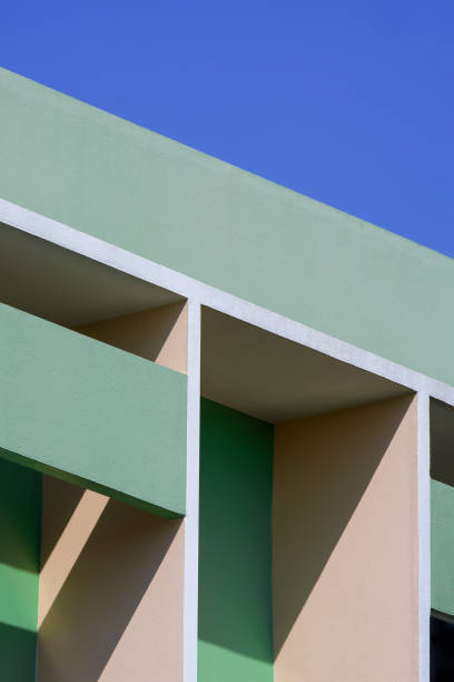 istock Abstract geometric pattern background of shading fin concrete on modern green and beige building wall against blue clear sky 1359488150