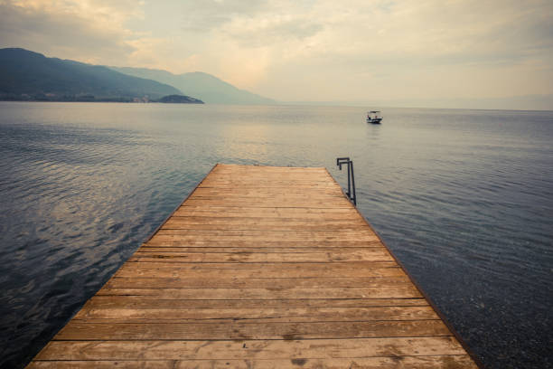 istock Wood pier pontoon on a lake 1359488566