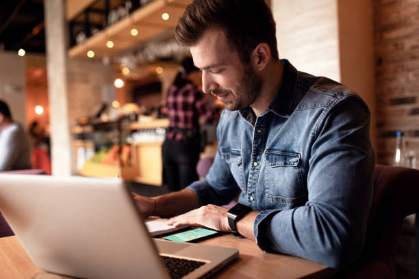 istock Young man working in coffee shop. 1359489698