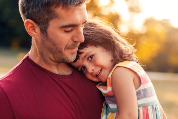 istock Happy father playing with his daughter in park. 1359489801