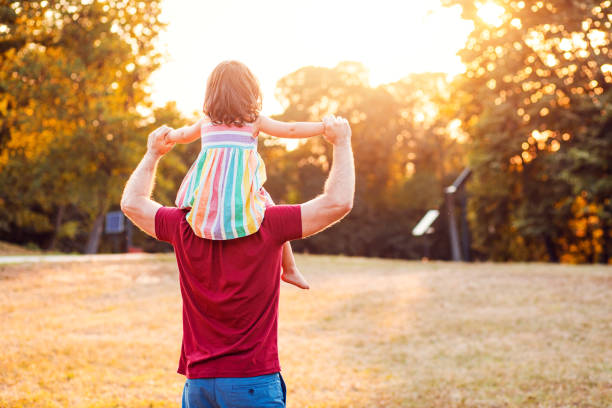 istock Happy father playing with his daughter in park. 1359490036