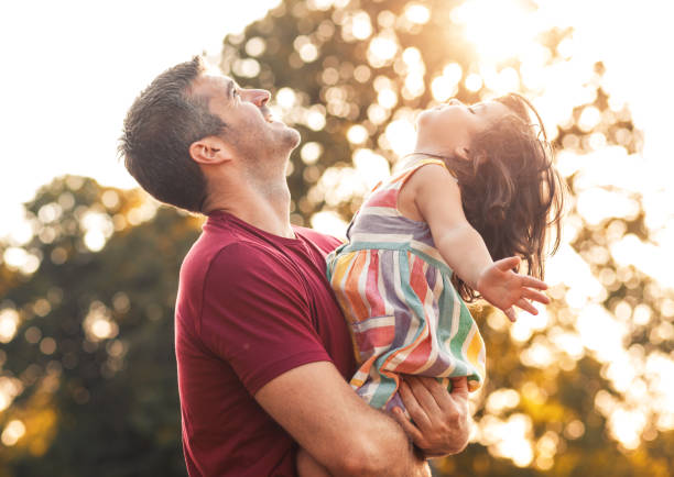 istock Happy father playing with his daughter in park. 1359490212