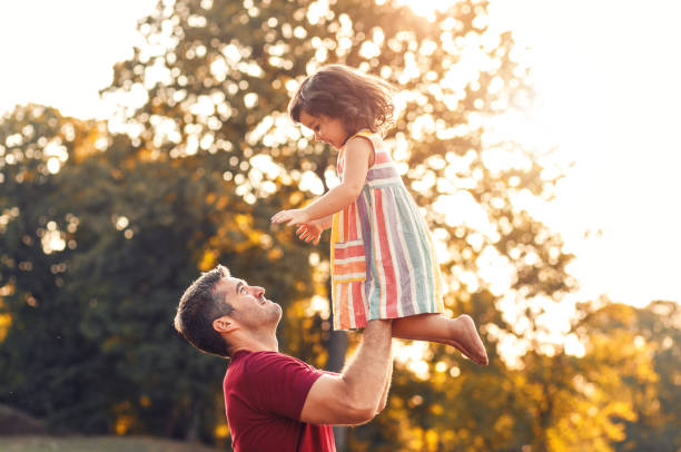 istock Happy father playing with his daughter in park. 1359490253