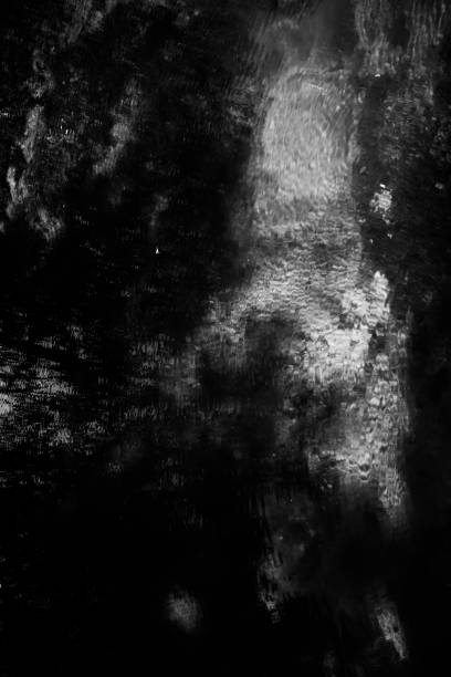 istock wild and fast water flow, black and white waterfall frame, blur and fuzziness 1359490927