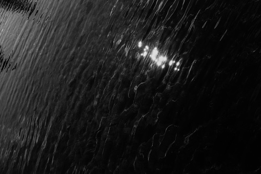 wild and fast water flow, black and white waterfall frame, blur and fuzziness