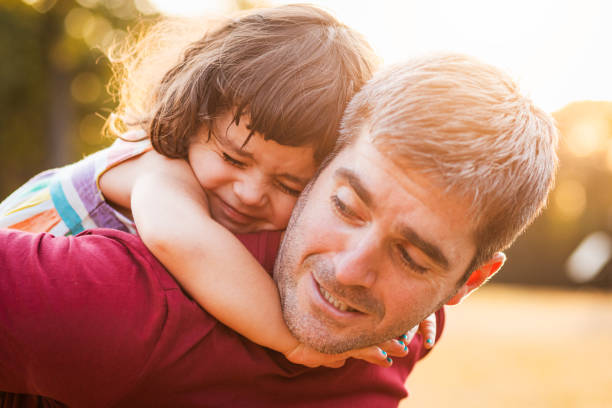 istock Happy father playing with his daughter in park. 1359491046