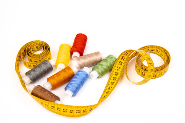 istock Sewing threads, sewing centimeter or measuring tape, isolated on white background. 1359491784