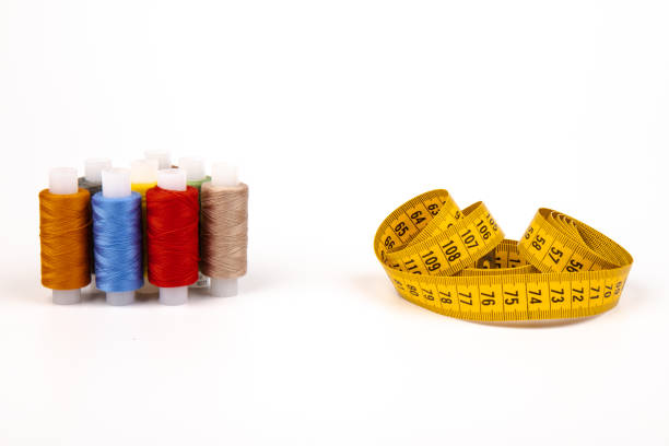 istock Sewing threads, sewing centimeter or measuring tape, isolated on white background. 1359492372