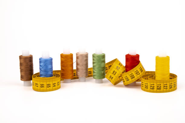 istock Sewing threads, sewing centimeter or measuring tape, isolated on white background. 1359492373
