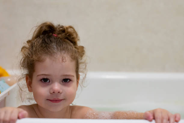 istock Little caucasian girl taking a bath, bathing a child 1359492891