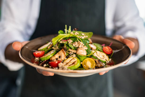 istock Chef Offers His Prepared Vegan Salad 1359493937