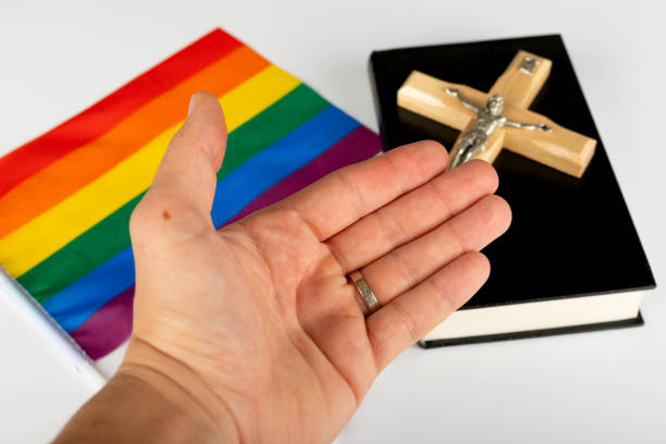 Same-sex marriage Picture of a bible, cross and a rainbow flag transgender friendly churches stock pictures, royalty-free photos & images