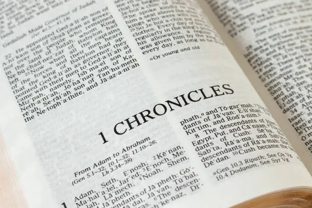 1 Chronicles open Holy Bible Book Old Testament Scripture. Christian prayer, faith, and belief in God Jesus Christ. Biblical study concept. A close-up.