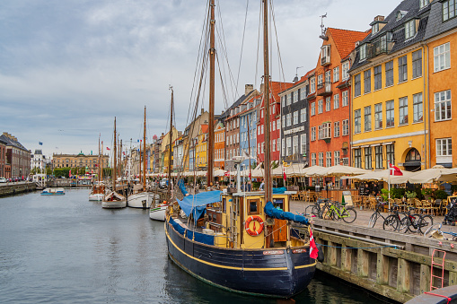 Copenhagen, Denmark - October 1, 2021: view of Nyhavn pier with colorful buildings and boats in Old Town of Copenhagen