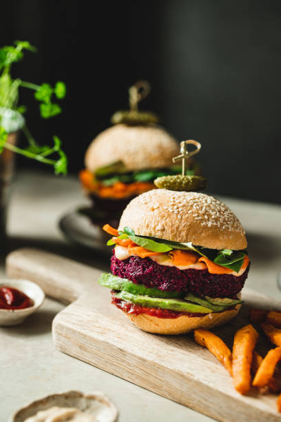 Vertical image of two beet vegan burgers