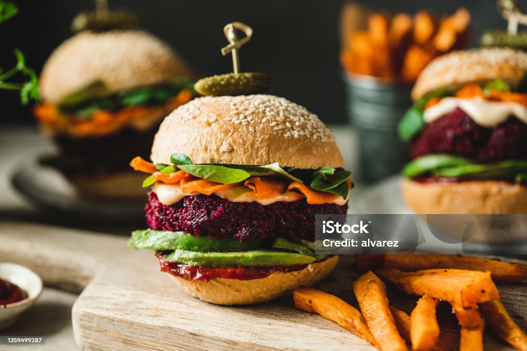 Vegan food served as vegan beet burgers Cropped image of three vegan burgers representing the quality of vegan food Vegan Food Stock Photo