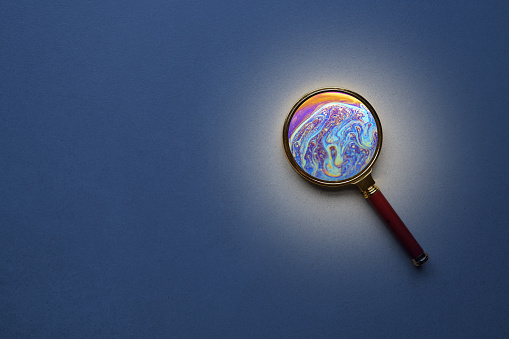 Metaverse concept. Magnifyning glass with planet