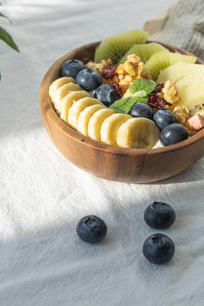 istock Bowl of yogurt with wild berries and fruit on white background. 1359502589