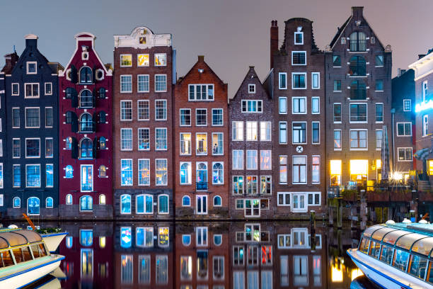 istock Dancing houses at Amsterdam canal Damrak Netherlands 1359502728