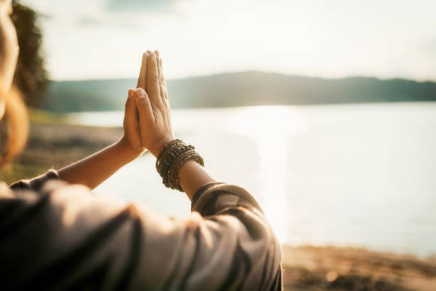 Namaste Woman doing namaste sign with hands against the sun hippie photos stock pictures, royalty-free photos & images
