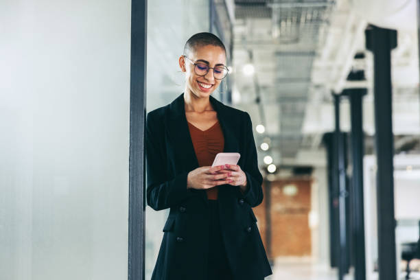 istock Cheerful businesswoman communicating with her partners using a smartphone 1359506370