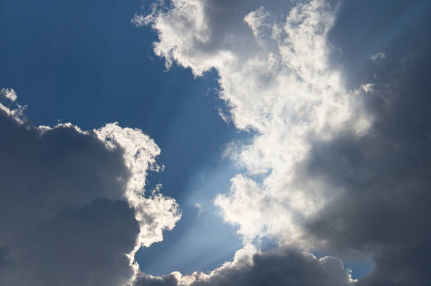 istock Clouds illuminated by the sun in the sky as background 1359507428